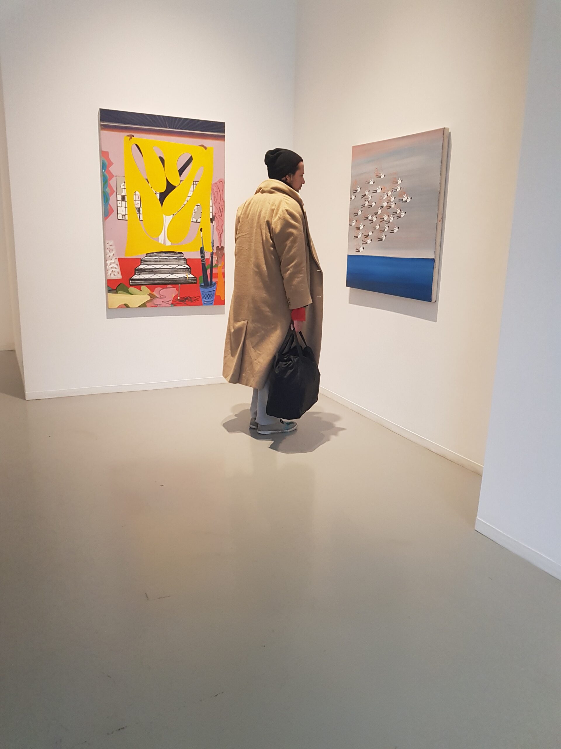 man looking at a painting in an Exhibition